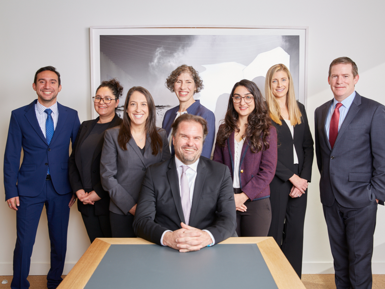 Group staff photo at a table.